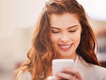 woman smiling sending emojis