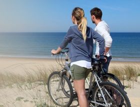 couple with bike at the beach