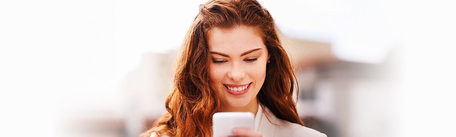 Beautiful woman checking out a professional dating site on her smartphone