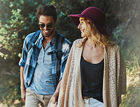 Couple exploring a botanic garden together on a sunny day