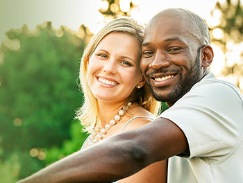 black and white couple smiling together