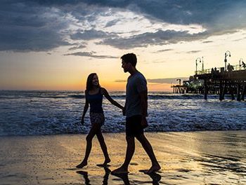 Couple walking on an Orange County beach