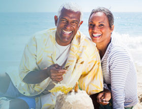 Couple laughing together on the beach