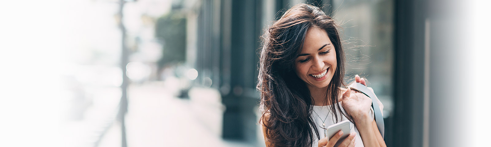 Beautiful woman using a dating service on her phone