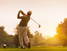 Man playing an early morning round of golf