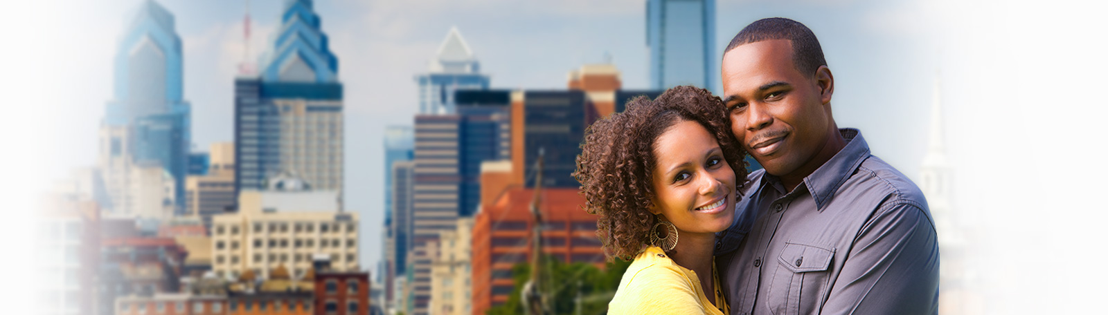 black couple in front of philadelphia skyline