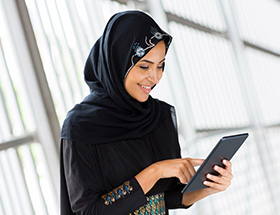 Single Muslim woman using her tablet