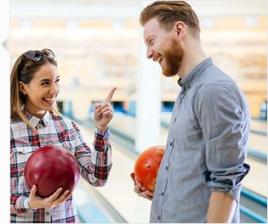 pretty woman and man bowling