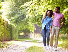 Happy couple taking an afternoon stroll on a sunny day