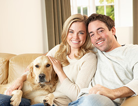 Attractive couple smiling with their dog who is a fan of Christian dating