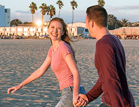Couple running along Venice Beach