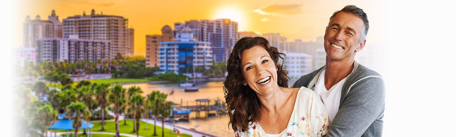 Happy Sarasota couple laughing with city in backdrop