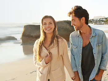 Couple walking at a romantic beach