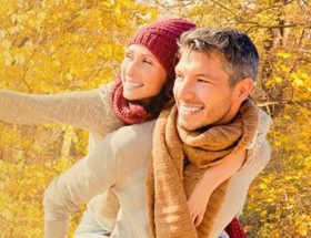 Couple out watching the fall leaves together