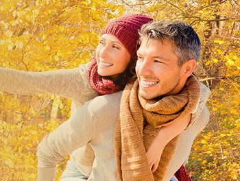 Couple out watching the fall leaves together