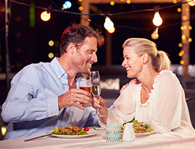 Couple clinking glasses in a restaurant