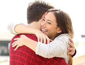 Beautfiul woman hugging a man