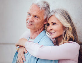 happy older couple hugging