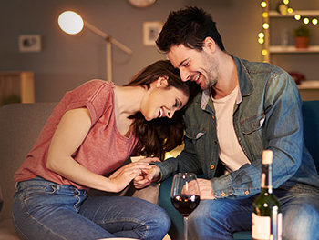 Man and woman snuggling on a sofa