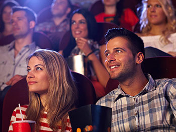 Couple at the movies eating popcorn