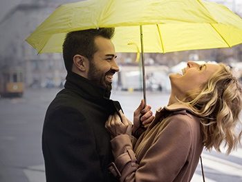 couple laughing under umbrella