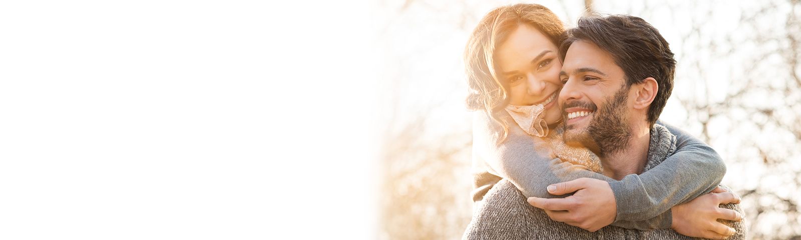 happy couple hugging in sunshine