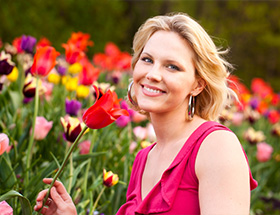Beautiful woman looking at tulips