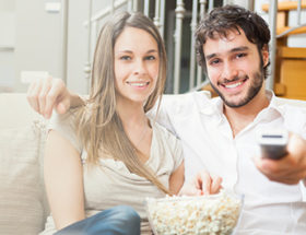 Man and woman watching TV together