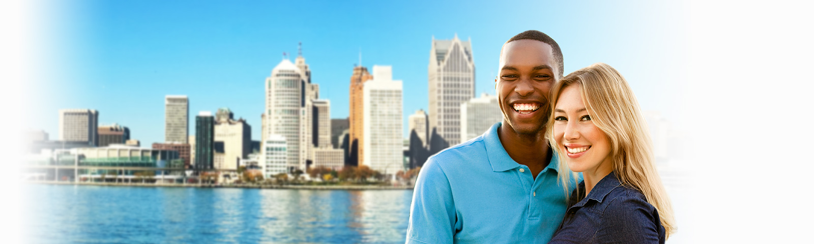 happy couple in front of Detroit cityscape