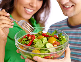 couple holding a salad