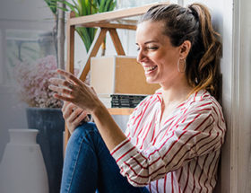 single woman laughing at her online dating messages