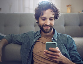 single man happy after asking someone out over text