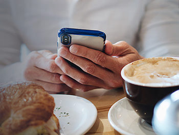 man reading dating tips for busy professionals on his smartphone