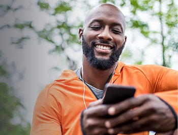 man on smartphone laughing at best opening lines for online dating