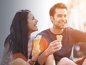 handsome man talking to a girl and making her laugh