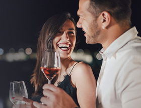 woman laughing with a man she finds attractive