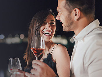 woman laughing with a man she finds attractive